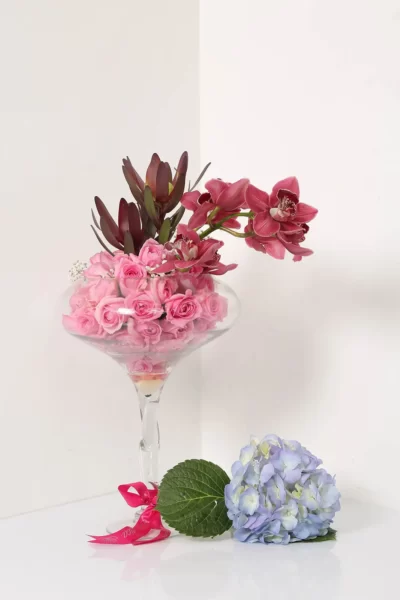 Glass Vase Arrangements Glass Vase of Cymbidium, Pink Roses & Sunset Safari