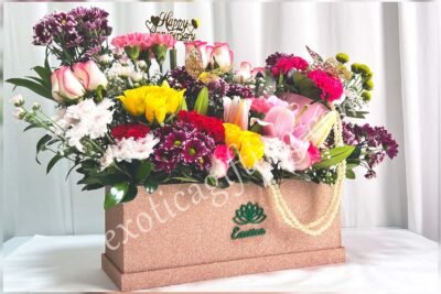 Box Arrangements Flower Arrangement of Jumilia Roses, Shaded Daisy, Yellow Roses with Golden Tag